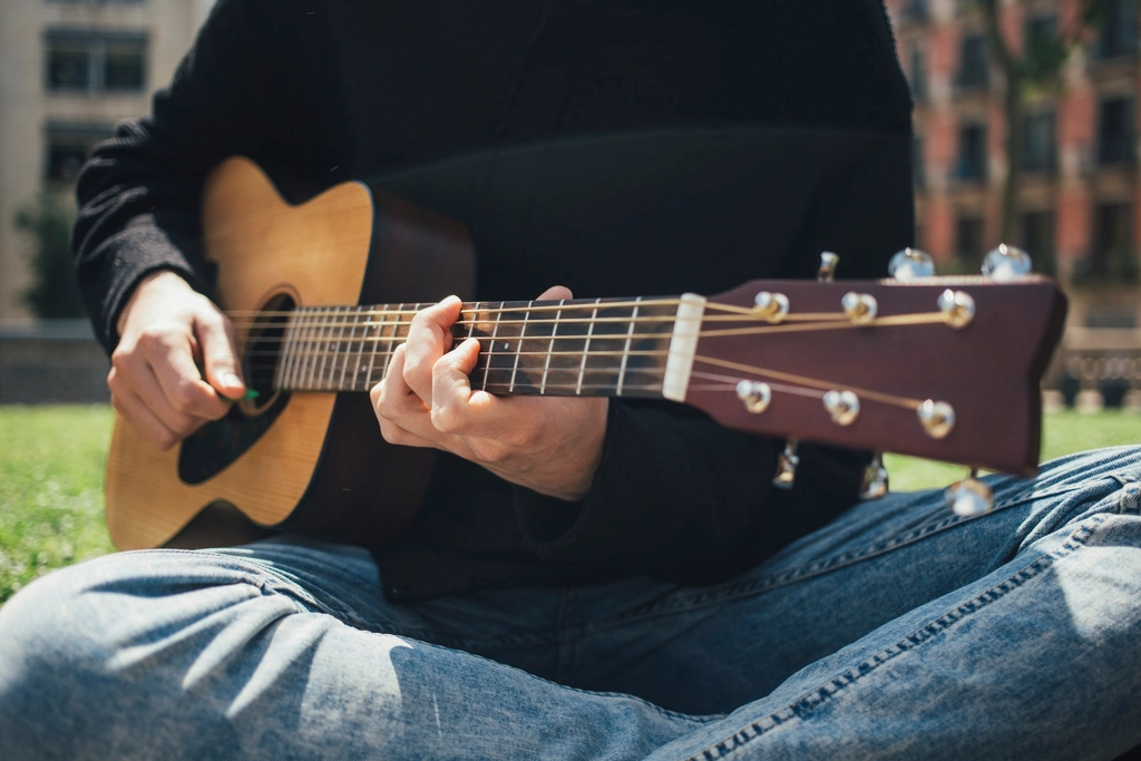 Someone playing an acoustic guitar